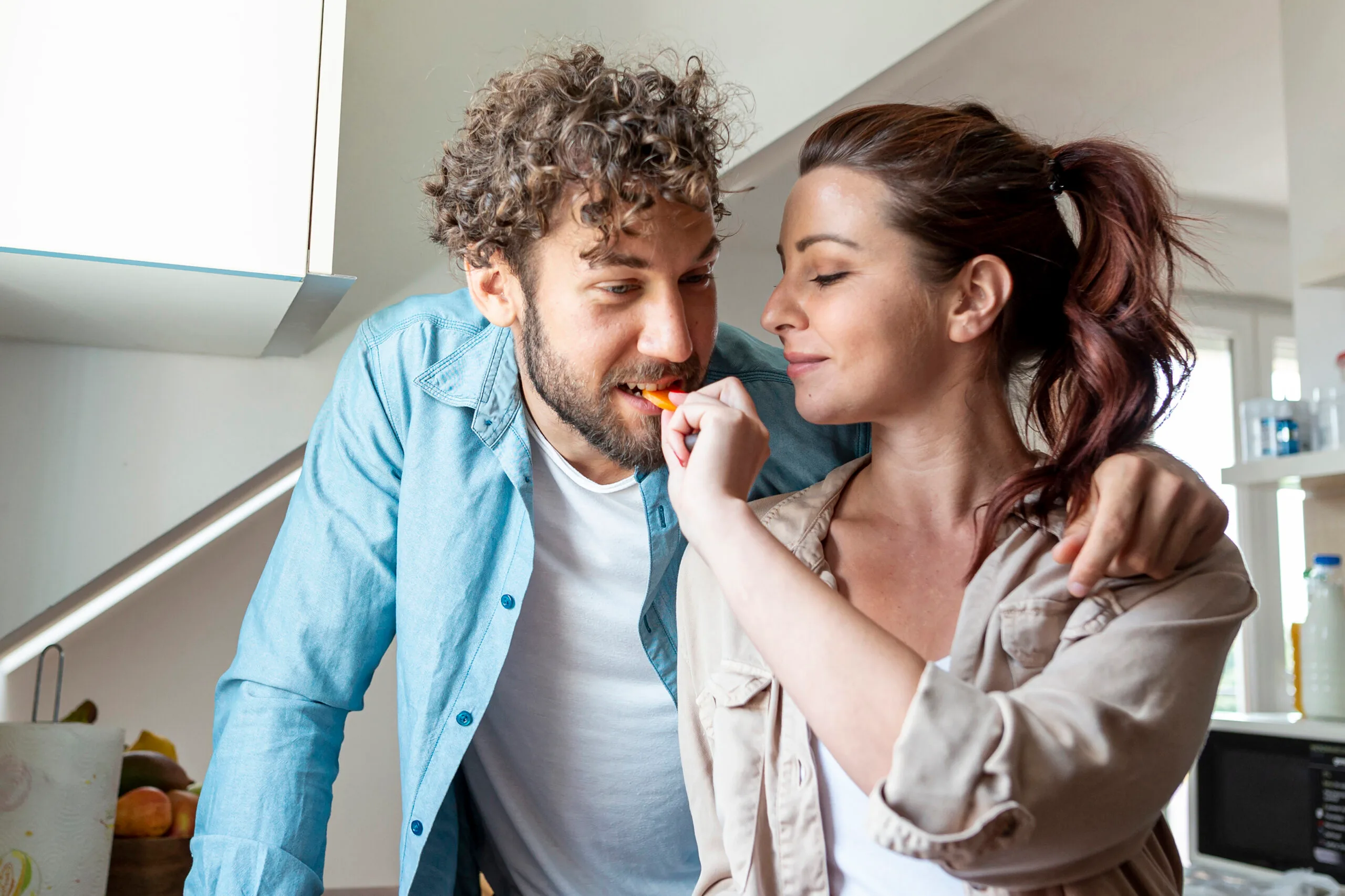 Woman feeding cookie to her man